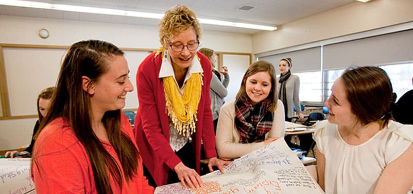 Literacy graduate students working with professor