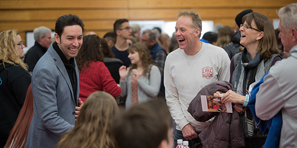 Parents and professor laughing at open house