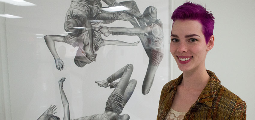 Leah Yerpe poses beside Syrinx, a photorealistic pencil drawing