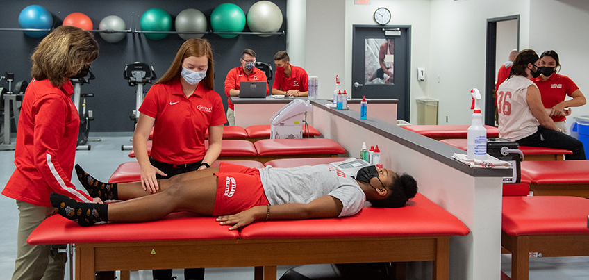 Students and professors work in the athletic training space on the ground floor of Park Center