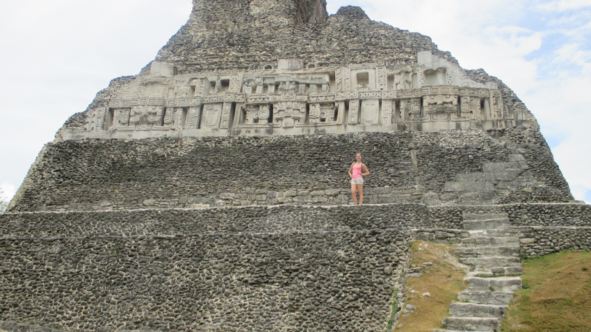 Student standing in front of the massive Xunantunich pyramid in Belize