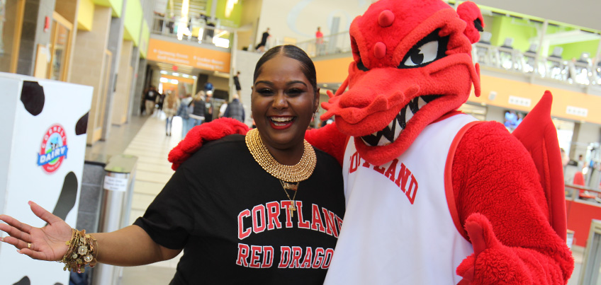 Khalia Banks poses with Blaze, the Red Dragon mascot, in the Student Life Center