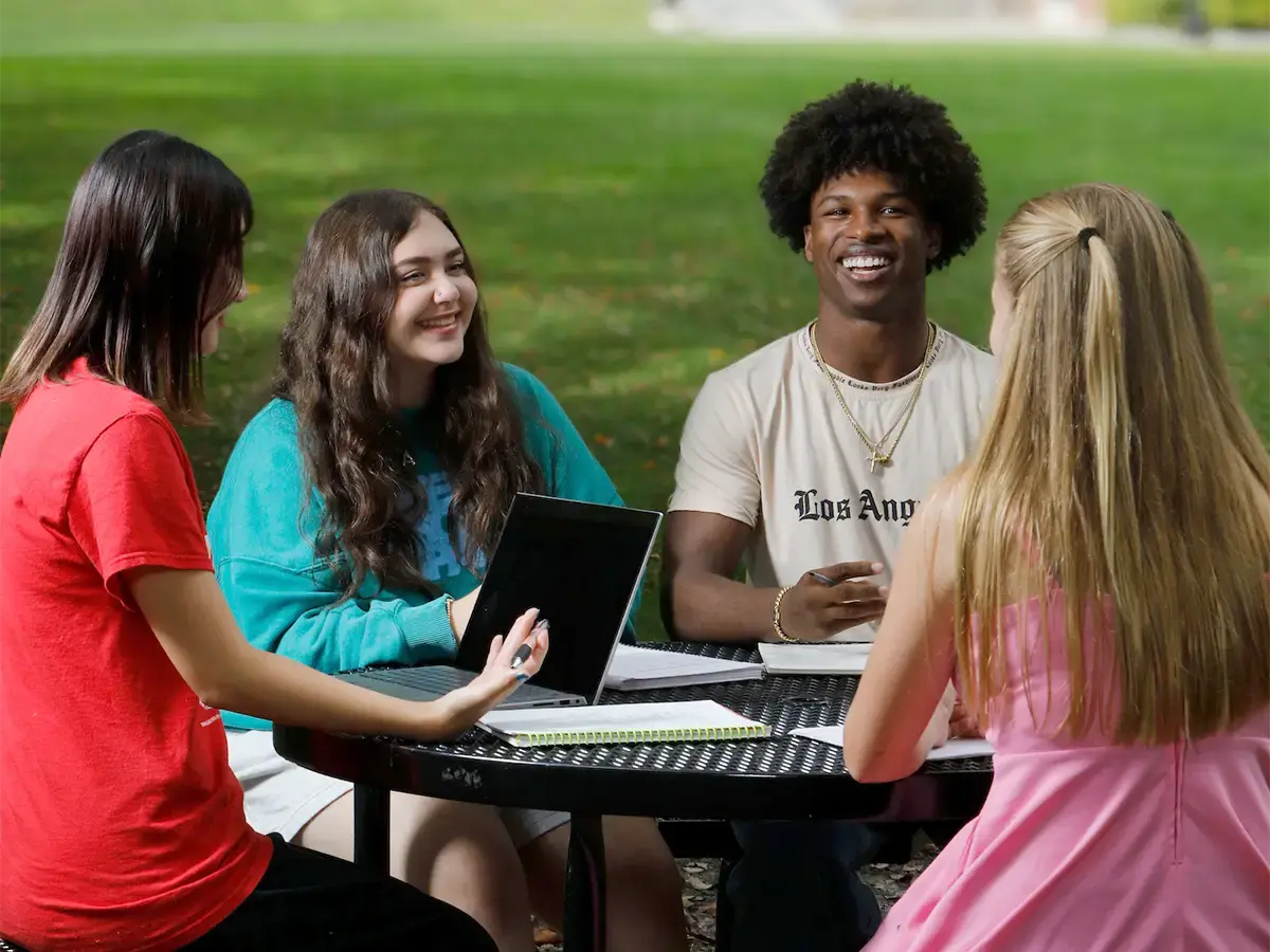 Students sitting around a table outside