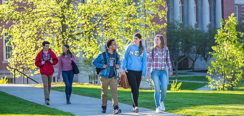 Students walking with Old Main in background