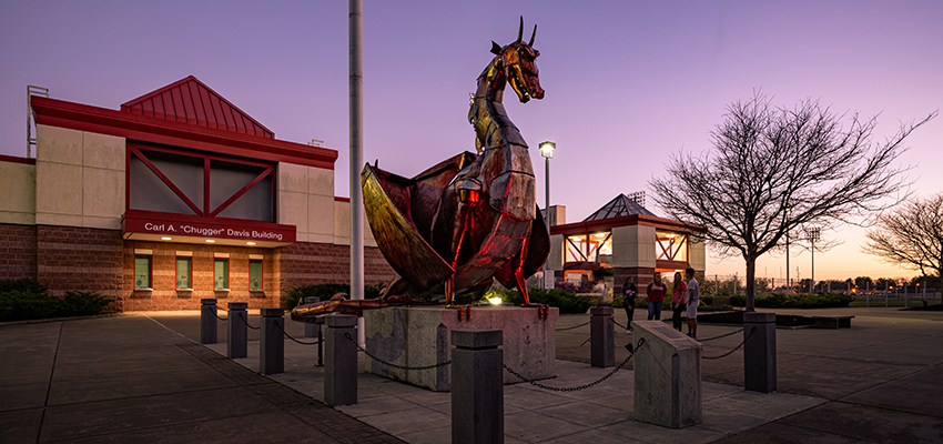 Red Dragon sculpture near Stadium Complex at sunset