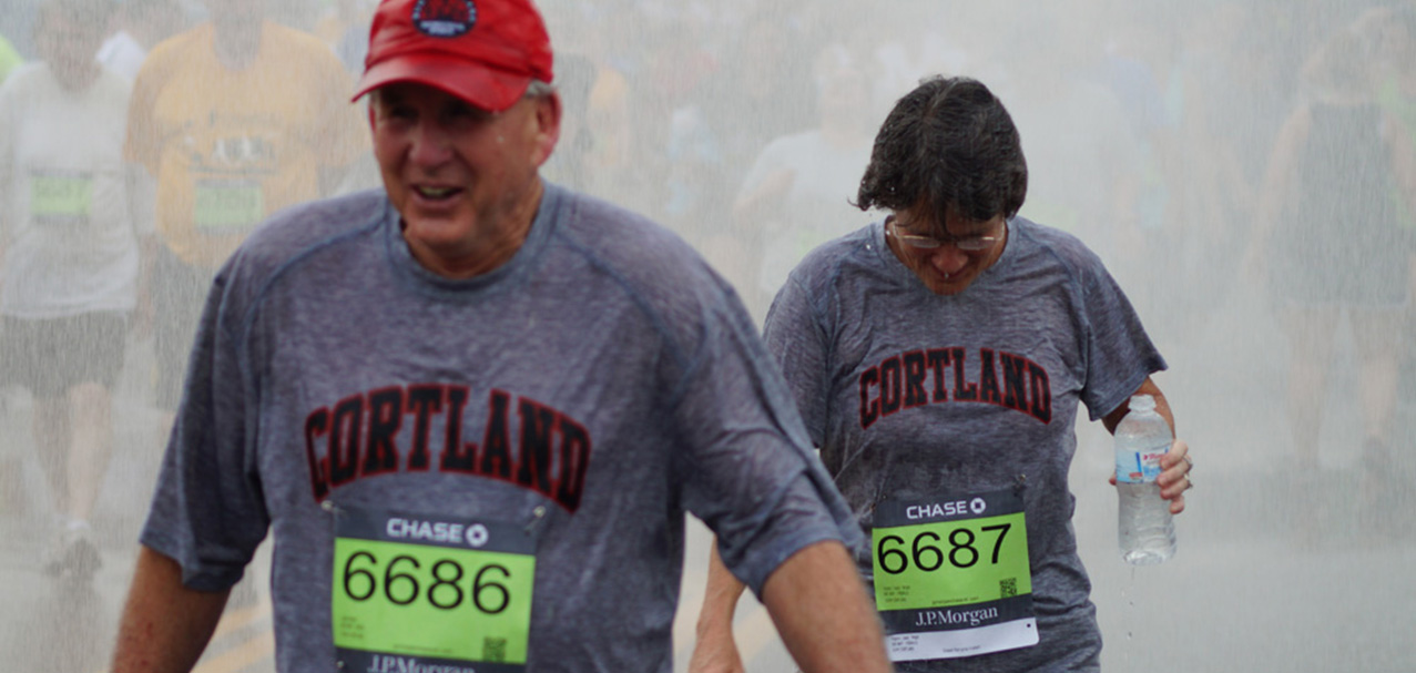 Corporate Challenge finishers doused in water on a hot day