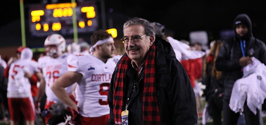 President Bitterbaum celebrates on the field after SUNY Cortland's football team earned the national championship in the 2023 Stagg Bowl in Salem, Va.