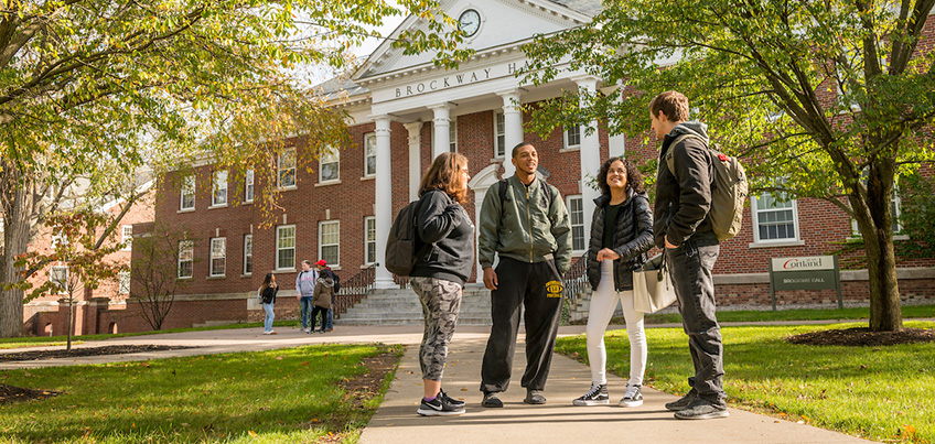 Students speaking in a group outside of Old Main