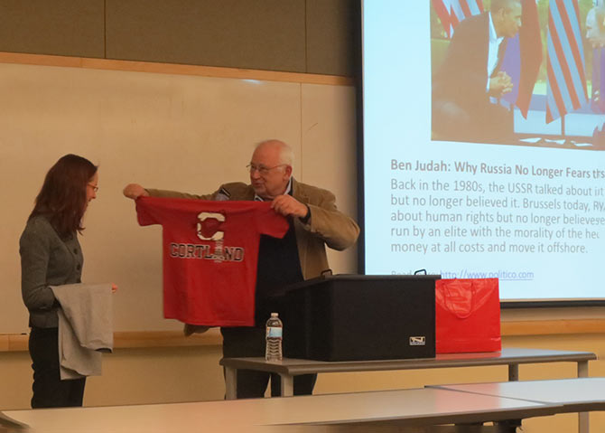 Prof. Henry Steck offers a Red Dragons gift to Ver Axyonova 