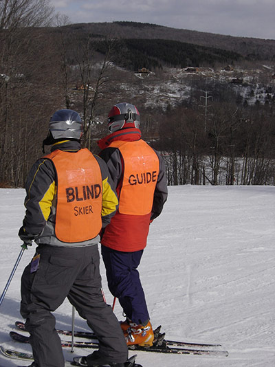 A guide skier with a blind skier