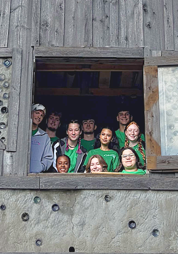 Green Reps posing in a barn window at the Freeville Earthship