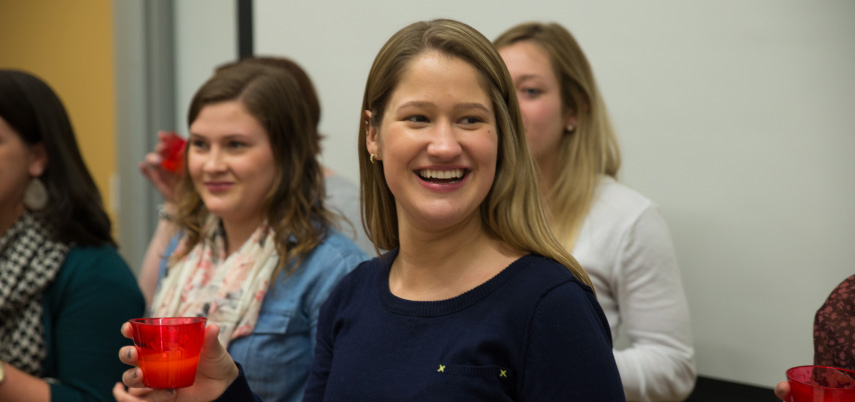 Graduate students doing the liquid challenge for dysphagia