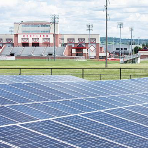 Solar panels with SUNY Cortland athletic facility in the background