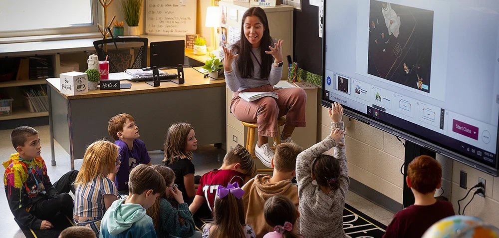 Teacher engaging young students with a presentation