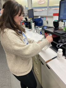 Cortland alum Fabiola Adorno Aguila working in a lab