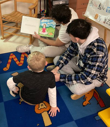 SUNY Cortland students reading to children in a local classroom