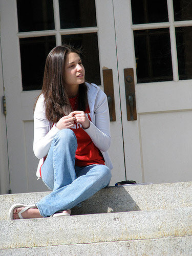 Girl sitting on the steps of a building