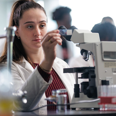 Student using microscope in a biology lab