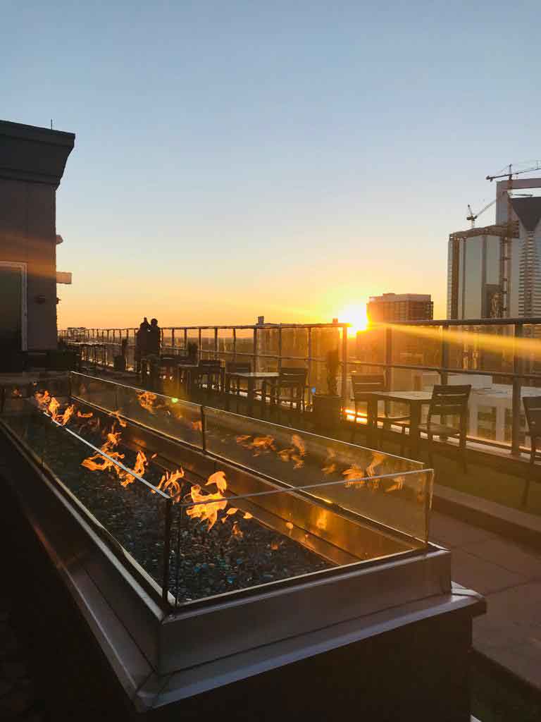 View of sunset behind buildings