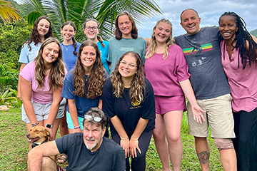 Students in Dominica pose with Associate Professor Jeremy Jimenez and Dominicans.