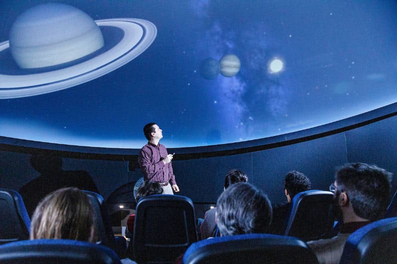 Instructor lecturing in the Planetarium