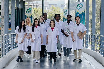 Group of students and faculty in white coats in Thailand