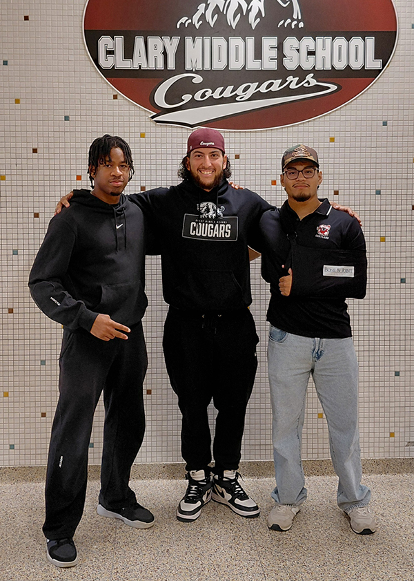Two C.U.R.E. students, Ikenna Okoye and Joe Martinez, posed for a photo with a C.U.R.E. mentor Andr&eacute;s Miranda in the middle