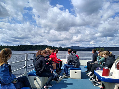 Students on a boat on Raquette Lake