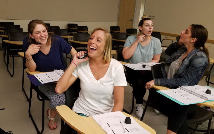 Students practice using the electrolarynx