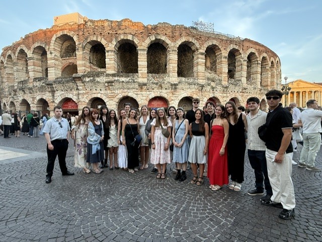 Group photo of Arts of Italy class outside of open-air venue in Italy