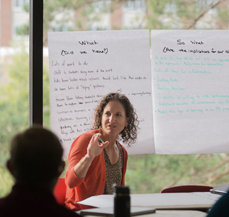 Teachers taking notes at a workshop