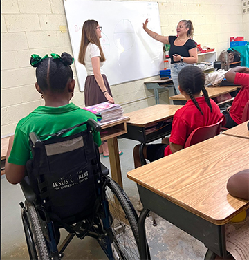 Cortland students inside a Dominica classroom.