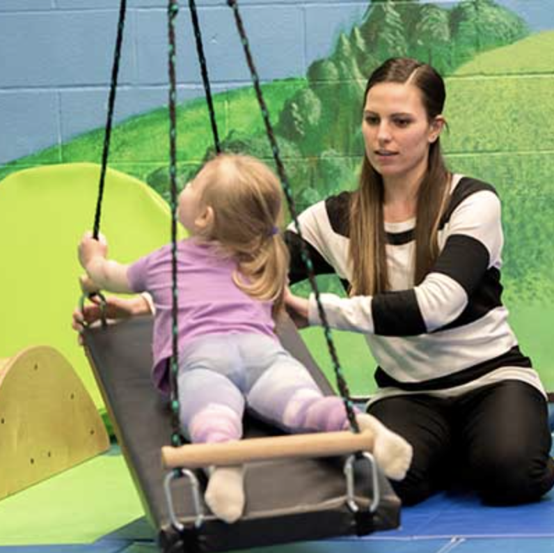 Physical Education student in exercise lab with child