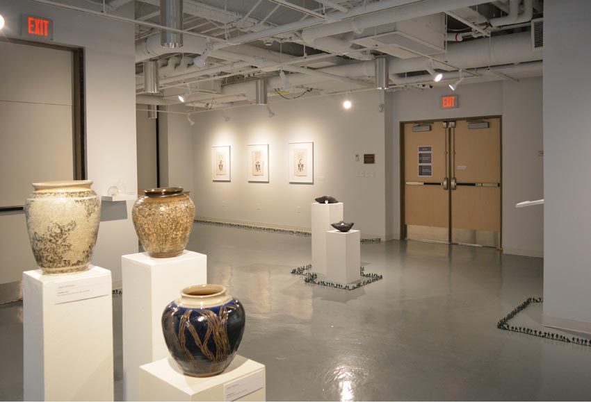 View into the central gallery at Dowd Gallery featuring sculptural objects produced by Jaroslava Prihodova, director of the Dowd Gallery, ceramics by Jillian McEvoy, instructor of ceramics, Jenn McNamara, professor of fiber arts, and installation by Bryan Valentine Thomas, instructor of design and drawing, at the Art and Art History Department.  