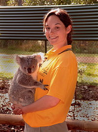 Student holding a koala