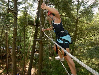 Student on the ropes course at Raquette Lake