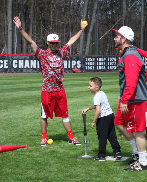 Baseball players volunteer at a "Fun on the Field" event for local boys