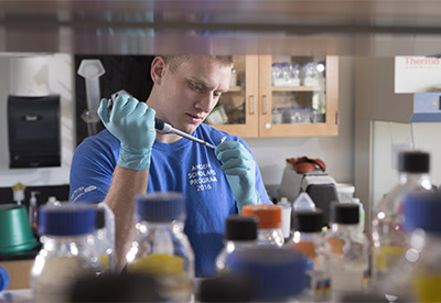 Tim Duerr, a SUNY Cortland biology major, conducts genetics research in a Bowers Hall laboratory.