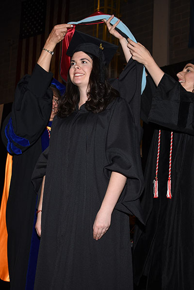 Student getting hooded by faculty at Hooding Ceremony