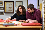 History professor working with a student on research