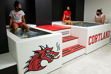 Student-athletes use hydrotherapy tubs in the athletic training facility.