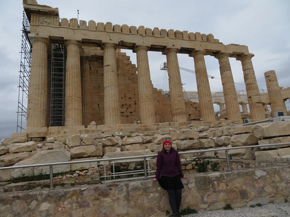 Person standing in front of the ruins of the Parthenon in Greece