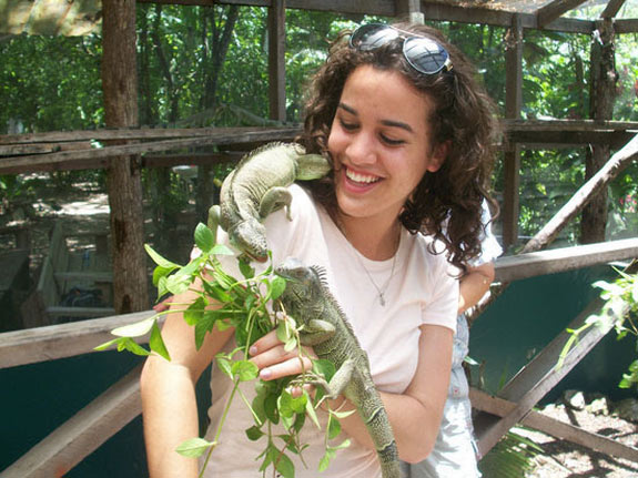 Student with iguana on her shoulder in Belize