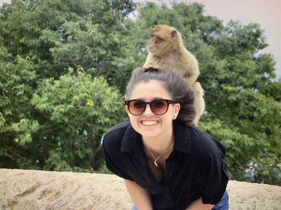 Smiling student with a monkey on her back
