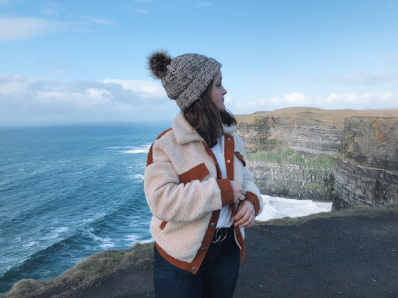 Student looking over a seaside cliff in Ireland