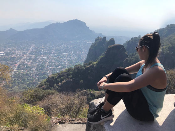 Student sitting in front of Overlook of Tepoztlan, Morelos, Mexico